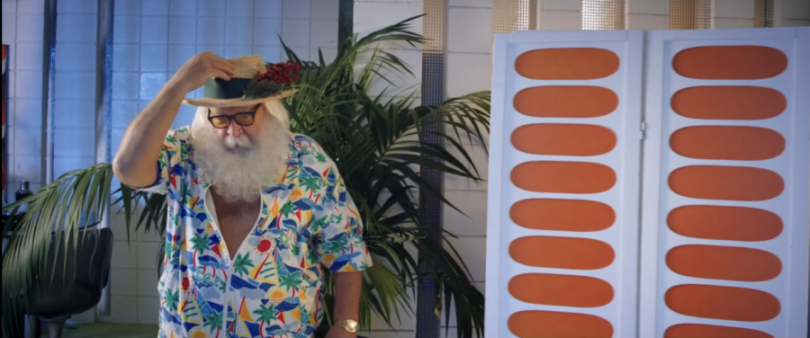 Santa Claus dressed in casual Hawaiian attire.