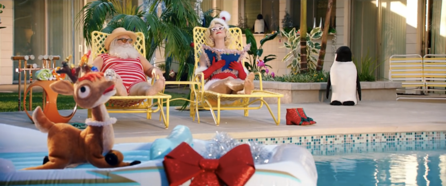 Katy Perry and Santa Claus relaxing beside a pool.