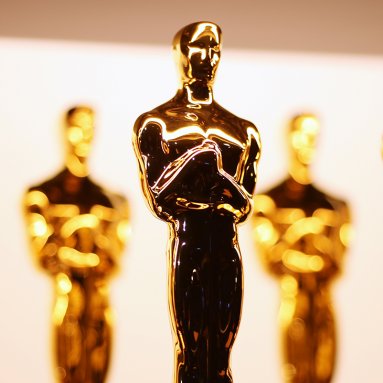A photo of three Oscar statuettes together.