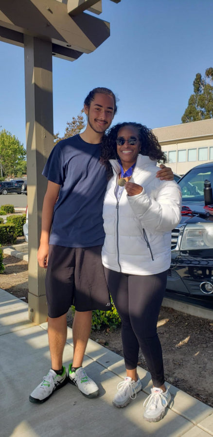Julian Jenkins and his mom, posing with the medal Julian won for winning the 2022 TCAL tennis championship. 